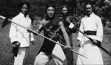 Jackie Chan in John Woo's Hand of Death. That's Woo behind Chan's left shoulder. from Jackie Chan: Inside the Dragon by Clyde Gentry III.